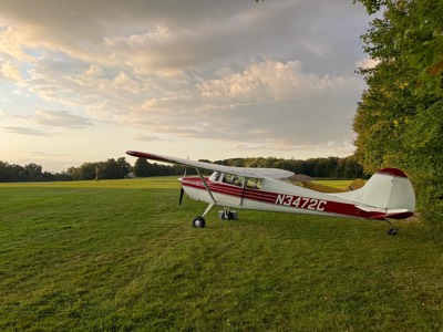 N3472C parked on the grass at Mount Tobe airfield at sunset